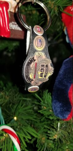 a close up of a christmas tree ornament with a key chain hanging from it