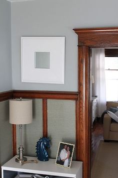 a living room with a couch, table and pictures on the wall next to it