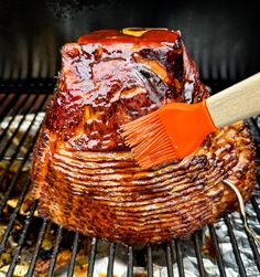 a bbq with ribs and barbecue brush on it