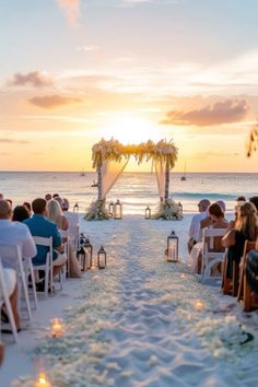 a wedding ceremony on the beach at sunset