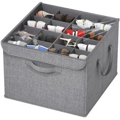 a large gray storage box filled with lots of pairs of shoes and other items in it