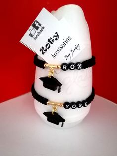 three graduation bracelets on top of each other