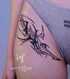 a woman's thigh with a tattoo design on the side and words written in japanese