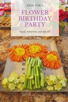 there is a flower birthday party with carrots and celery