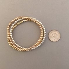 "14k gold fill, rose gold fill, or sterling silver balls are strung onto a stretchy elastic cord. Balls measure 3 mm (approximately 1/8 of an inch). Available as a single bracelet or a set of 3. Great piece to layer! 4mm ball bracelet is here: https://www.etsy.com/listing/694393921/4mm-beaded-ball-bracelet-in-gold-fill 5mm ball bracelet is here: https://www.etsy.com/listing/694396085/5mm-beaded-ball-bracelet-in-gold-fill YOUR ORDER - Choose the number of bracelets you want in the drop-down menu, Rose Gold Hand-strung Bracelets With Round Beads, Stackable Rose Gold Beaded Bracelets, Rose Gold Stackable Stretch Bracelet With Round Beads, Rose Gold Stackable Beaded Bracelets, Rose Gold Stackable Bracelet With Round Beads, Hypoallergenic Rose Gold Jewelry With Round Beads, Hypoallergenic Rose Gold Bracelet With Round Beads, Colorful Gift Wrapping, Single Bracelet