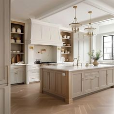 a large kitchen with an island in the middle and lots of cupboards on both sides