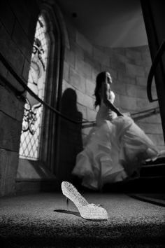 a woman in a wedding dress and high heeled shoes on the ground next to stairs