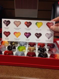 a red box filled with lots of different types of candies in it's display