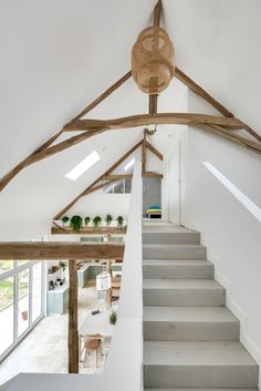 an open floor plan with white walls and wooden beams