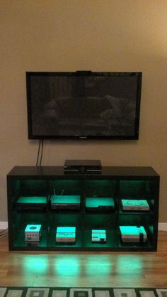 a flat screen tv sitting on top of a wooden entertainment center in a living room