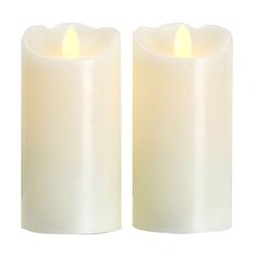 two white candles sitting next to each other