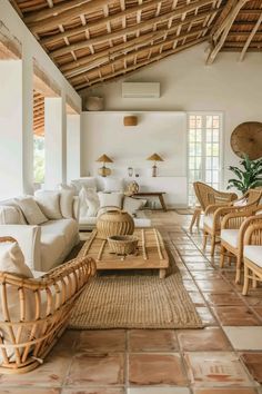 a living room filled with lots of furniture and decor on top of tile flooring