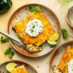 three plates filled with mexican food and topped with sour cream