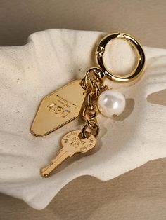 Composition : Brass, acrylic pearlColor : Gold,WhiteCountry of Origin : KOREA Key Ring Gucci, Stanley Accessories Aesthetic, Keychain Inspo Aesthetic, Trendy Keychains, Aesthetic Keychain, Aesthetic Products, Key Charms, Car Aesthetic, Wristlet Keychain