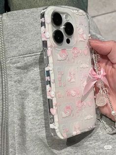 a person holding a cell phone case with a pink bow on the front and back