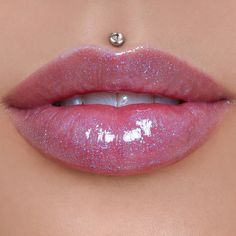 a woman's lips with glitter on them and a nose pin in the middle