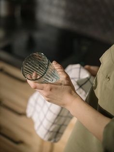 a woman holding a glass in her hand