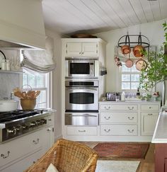 a kitchen with an oven, stove and wicker chair next to the counter top