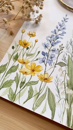 a watercolor painting of yellow and blue flowers