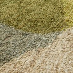 an area rug with different colors and patterns on the floor, including green, yellow, gray