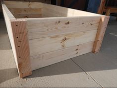 a large wooden box sitting on top of a floor