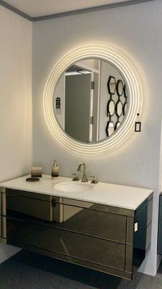 a bathroom with a sink and mirror on the wall