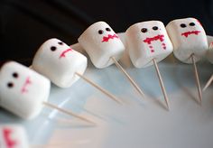 marshmallows with faces are arranged on a plate