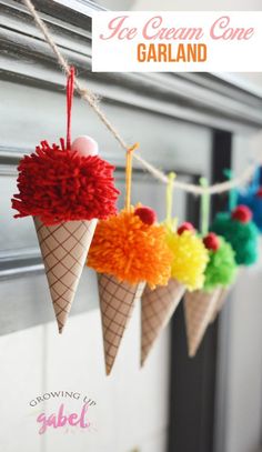 an ice cream cone garland with pom - poms hanging from it