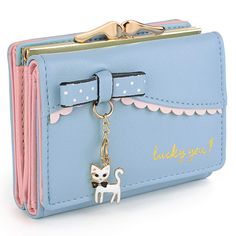 a purse with a key chain attached to it and a cat charm hanging from the front