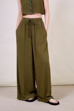 - Fit: True to size- Materials: 70% rayon, 30% linen- Thickness: Moderate- Sheerness: None- Stretch: None- Lining: None- Care: Dry clean or hand wash cold and dry flat in shade Drawstring Trousers, London Free, Fresh Design, Green Fashion, Parachute Pants, Fashion Brand, Olive Green, Harem Pants, Dry Clean