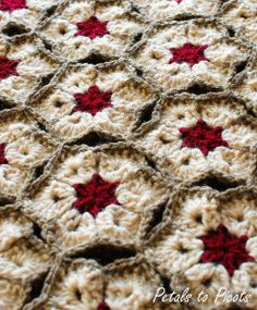 a crocheted blanket with red and white stars is shown in the middle of it