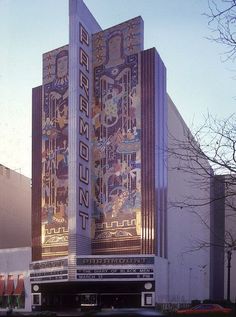 an art deco building in front of a parking lot