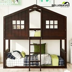 a wooden bunk bed with green pillows and blankets on it's bottom level, next to a white wall