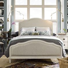 a bedroom with blue walls and white furniture