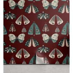 a red wallpaper with butterflies and moths on it, in the middle of a room