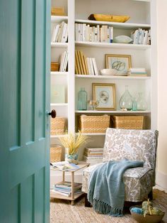 the interior of a living room with blue and white decor on it's walls