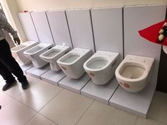 a row of white toilets sitting next to each other