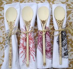 four wooden spoons tied together with rope