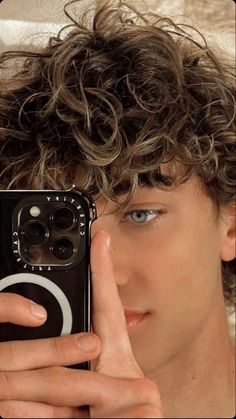 a young man taking a selfie with his cell phone