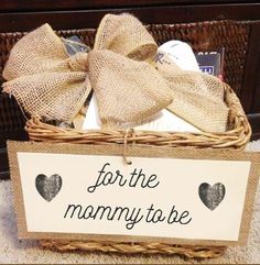 a basket with a sign that says for the mommy to be and two hearts on it