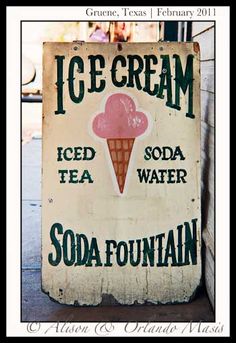 an old ice cream sign on the side of a building