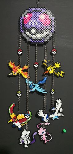 an image of a beaded mobile phone case with pokemon characters hanging from it's sides