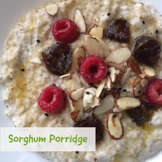 a bowl filled with oatmeal topped with raspberries and almonds