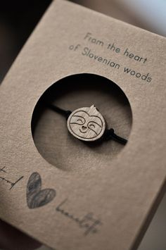 a book with a small wooden brooch on it's cover and the words from the heart of slevenan woods written in curs