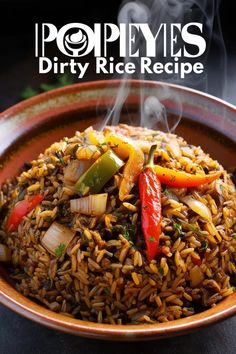 a bowl filled with rice and vegetables on top of a table