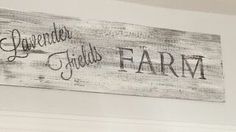 a wooden sign that says, the lavender fields farm on it's wall above a bed