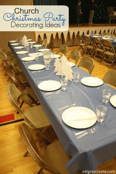 a long table set up for a christmas party with place settings and napkins on it