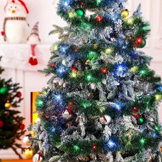 a decorated christmas tree in front of a fireplace