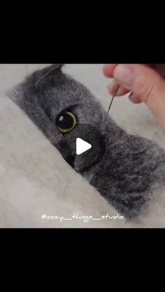 someone is using scissors to cut the fur off of a stuffed animal's head