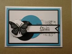 a close up of a card with a butterfly on the front and an arrow on the back